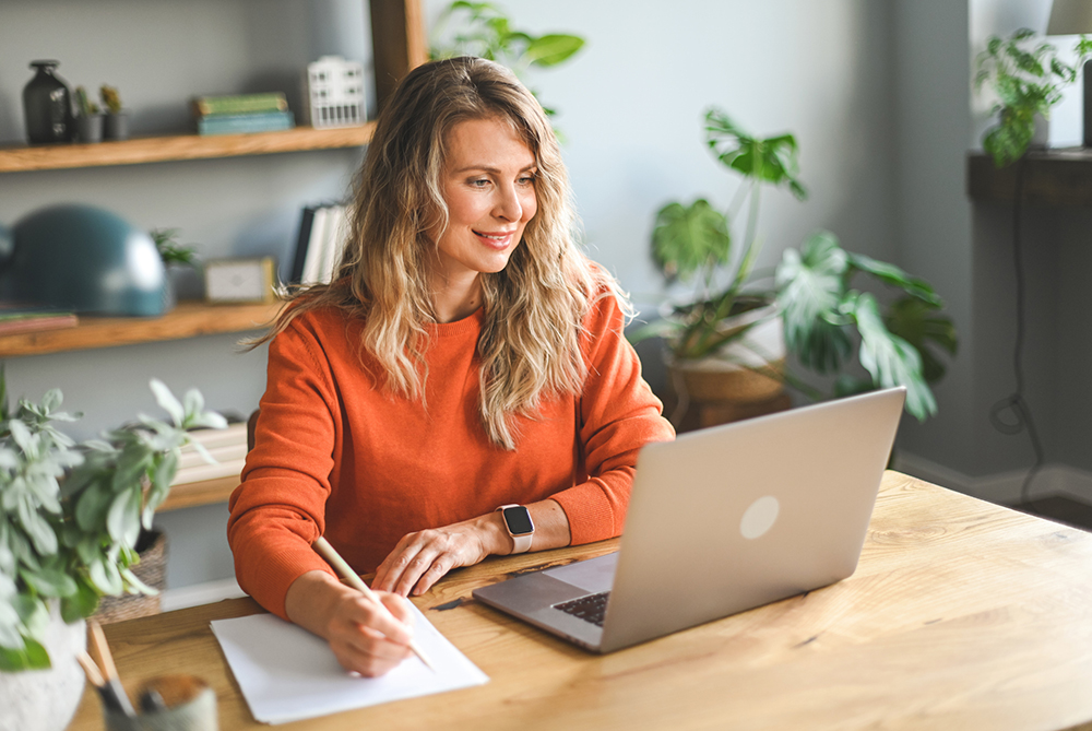 female at a desk looking at a computer