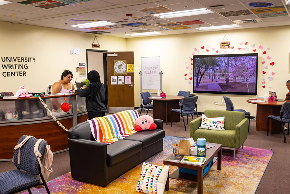 a student and staff standing at UNCP writing center