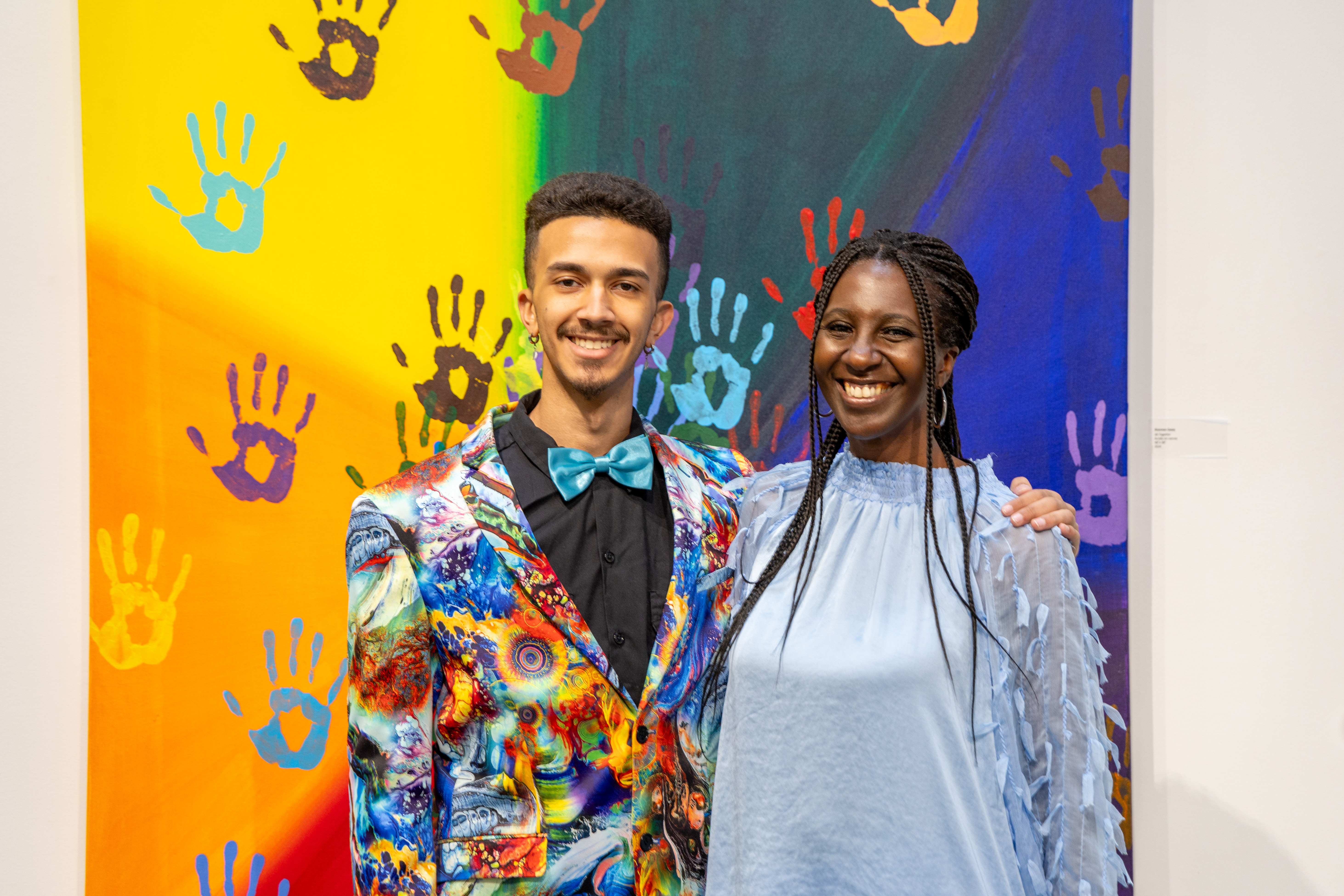 UNCP art student and his mom in front of an art display at the AD gallery
