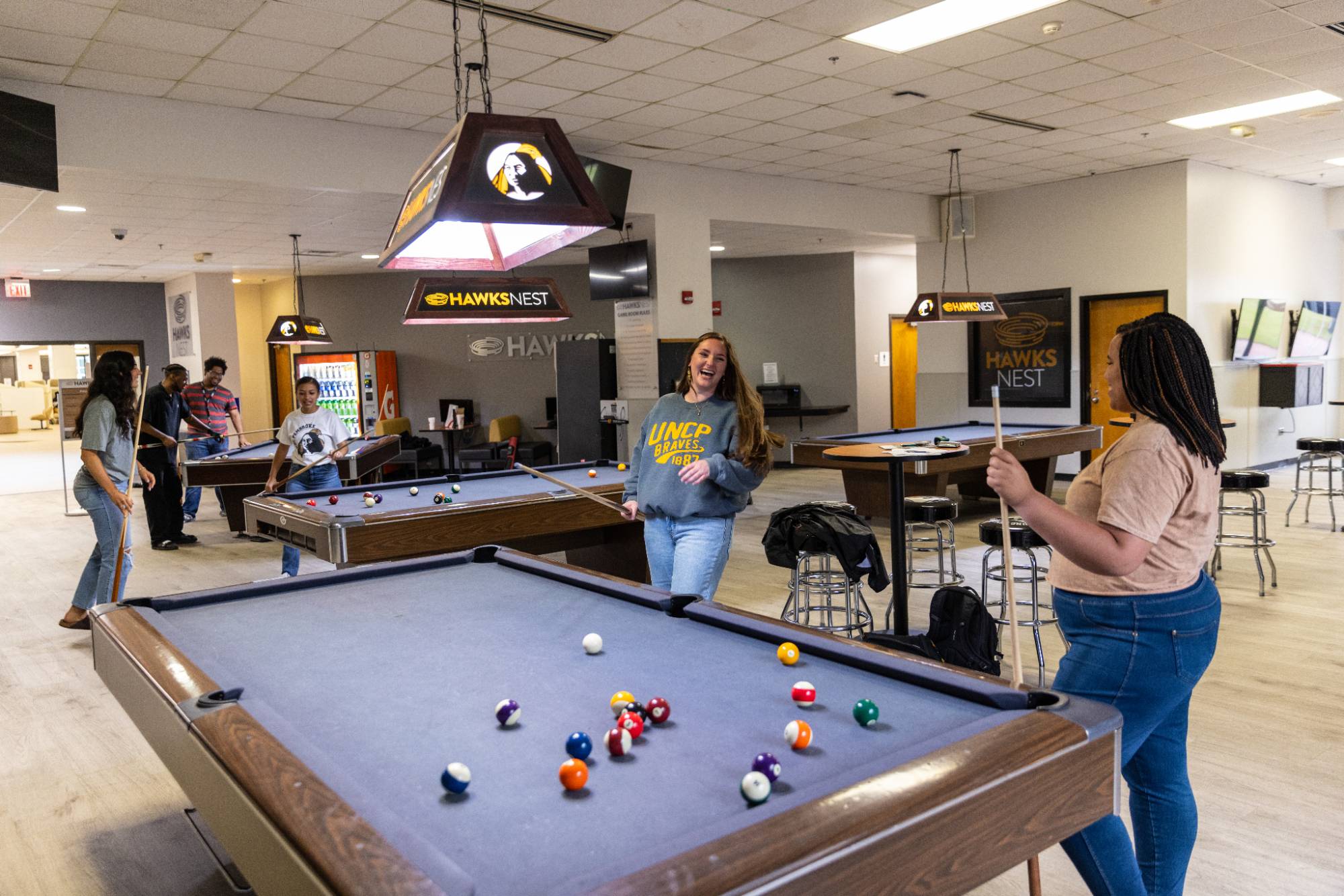 Students playing billiards in the HawksNest