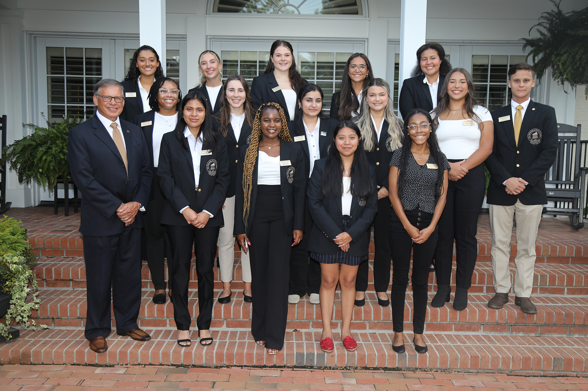 Group of student ambassadors standing with the UNCP Chancellor Dr. Robin Gary Cummings