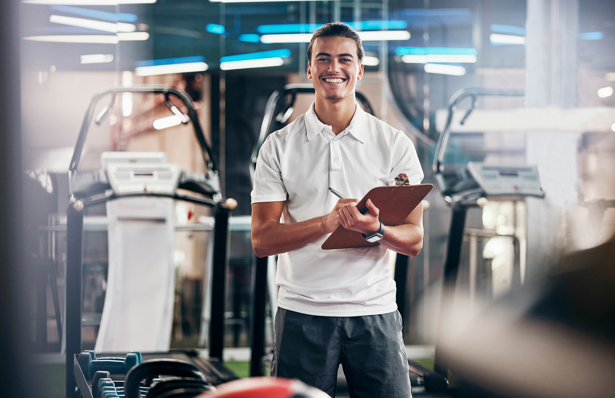 man in gym with clipboard