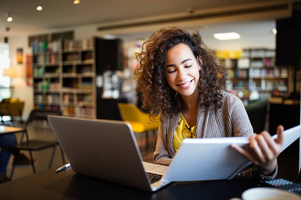 woman at a laptop smiling
