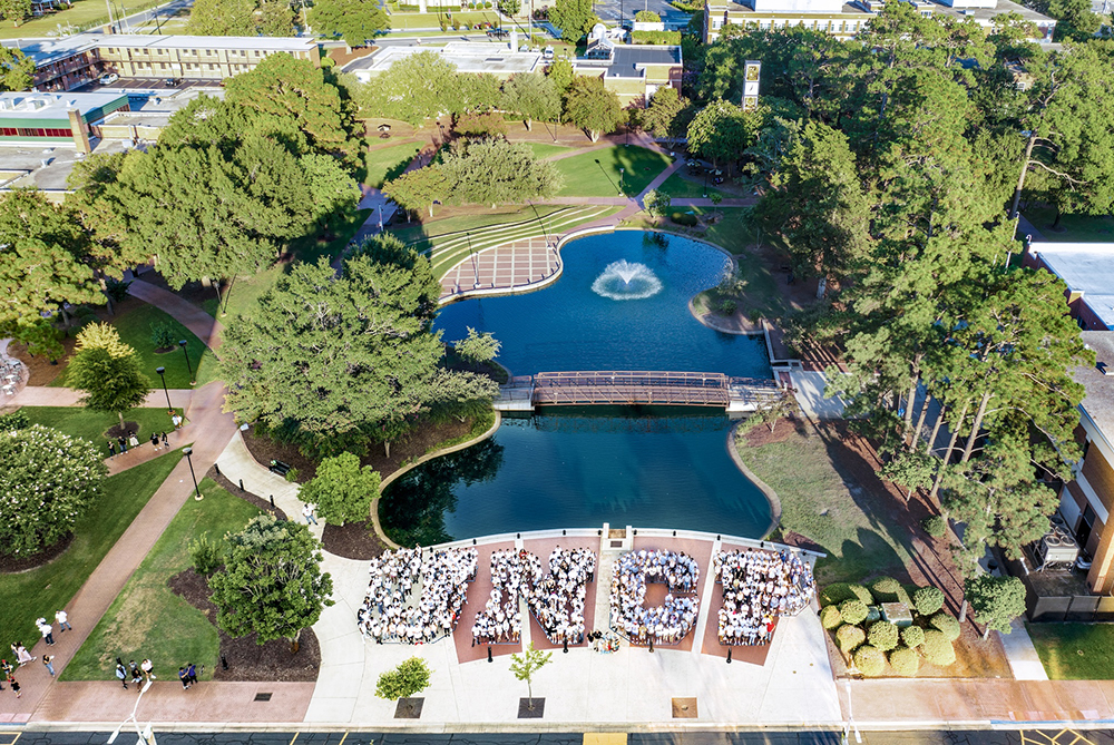 UNCP students in front of water feature