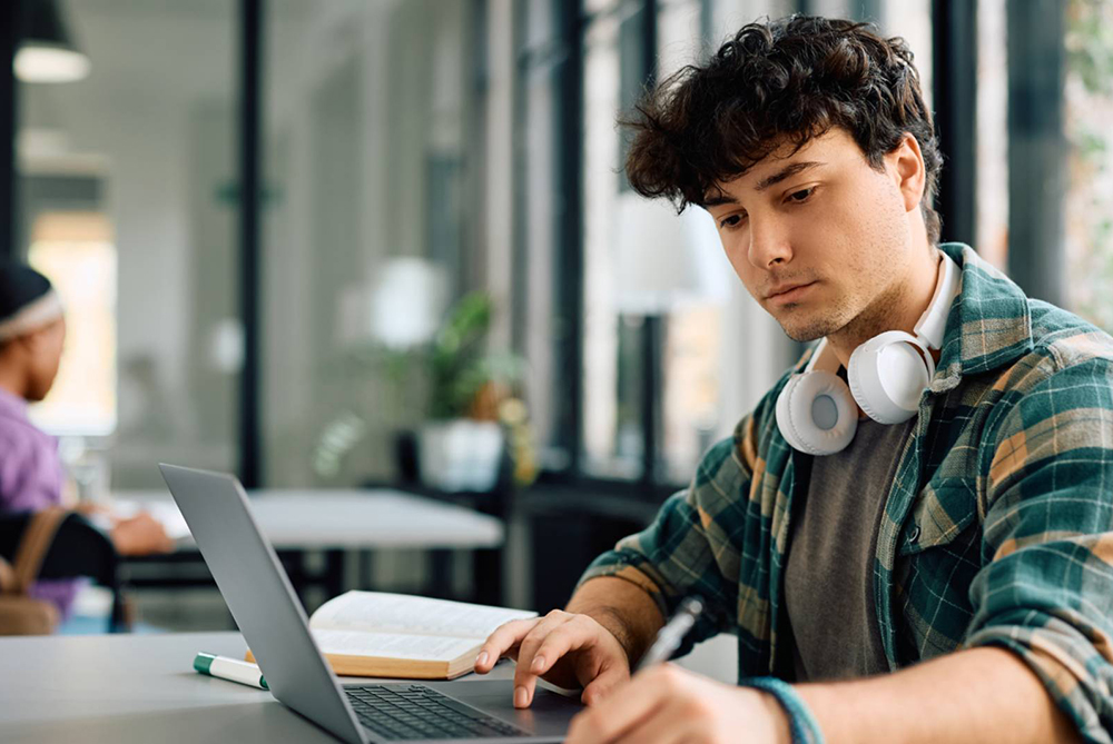 student sitting at computer studying