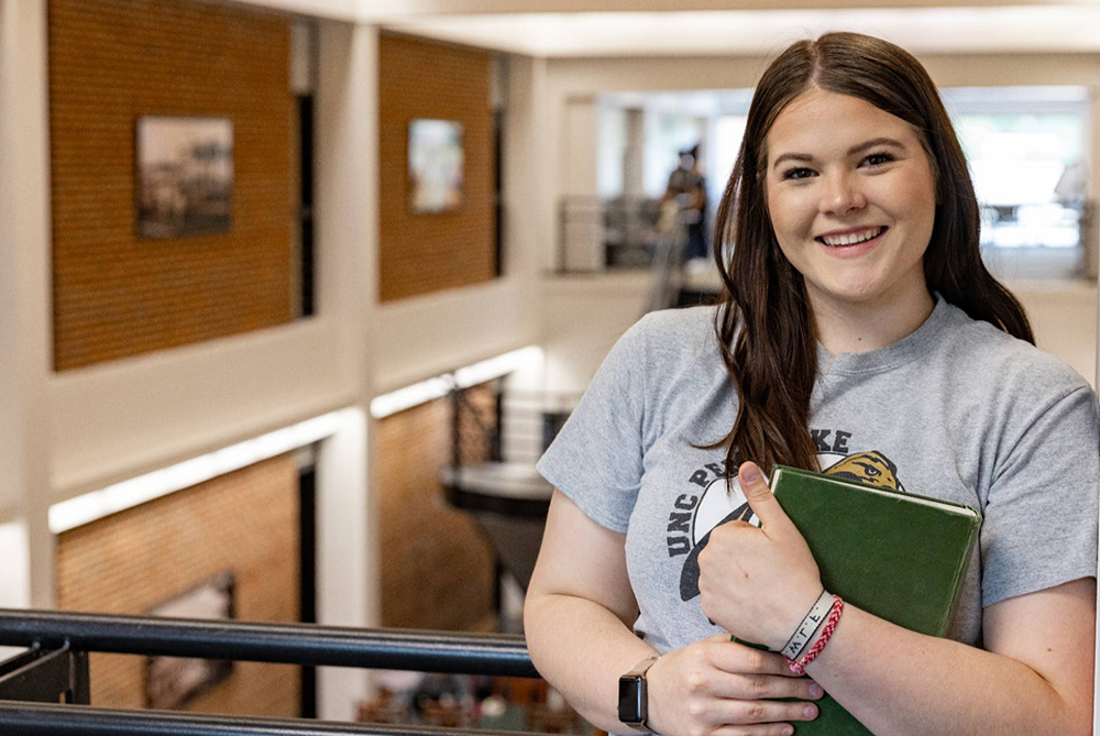 girl standing with book