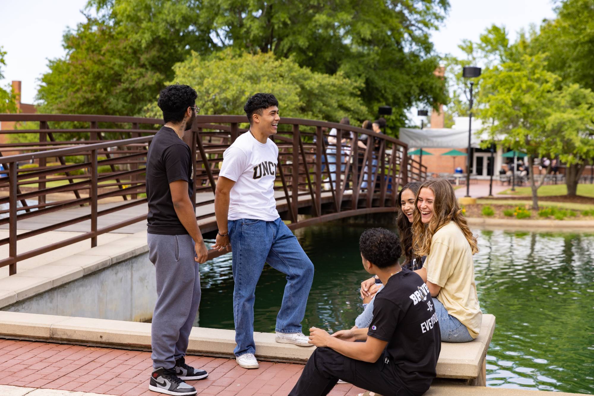 students in a group outside water feature