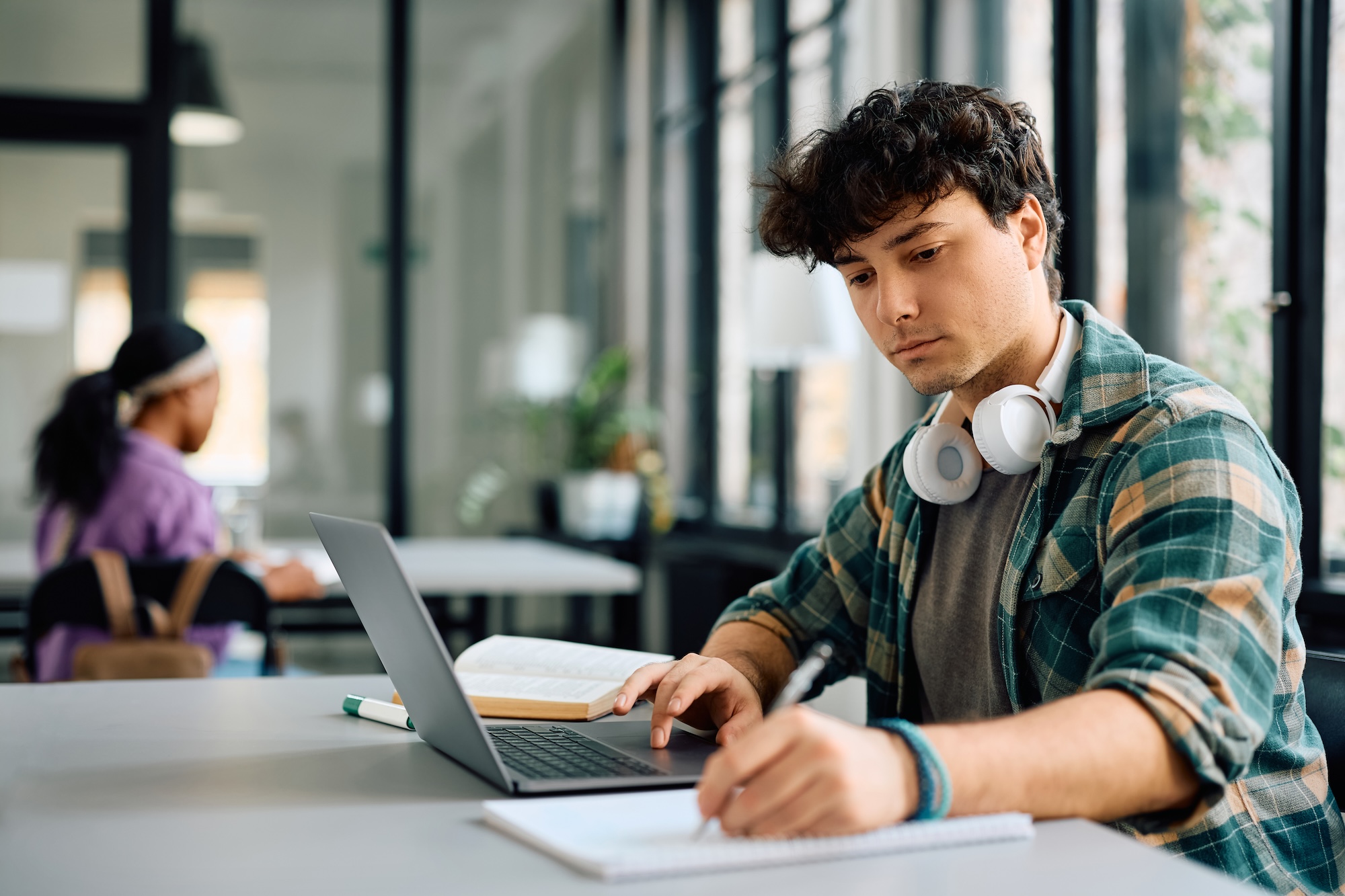 Male student doing school on a laptop
