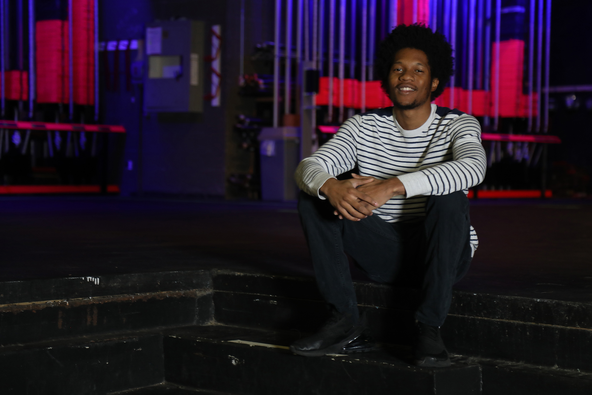Jamonte Madison sits on the steps of the stage