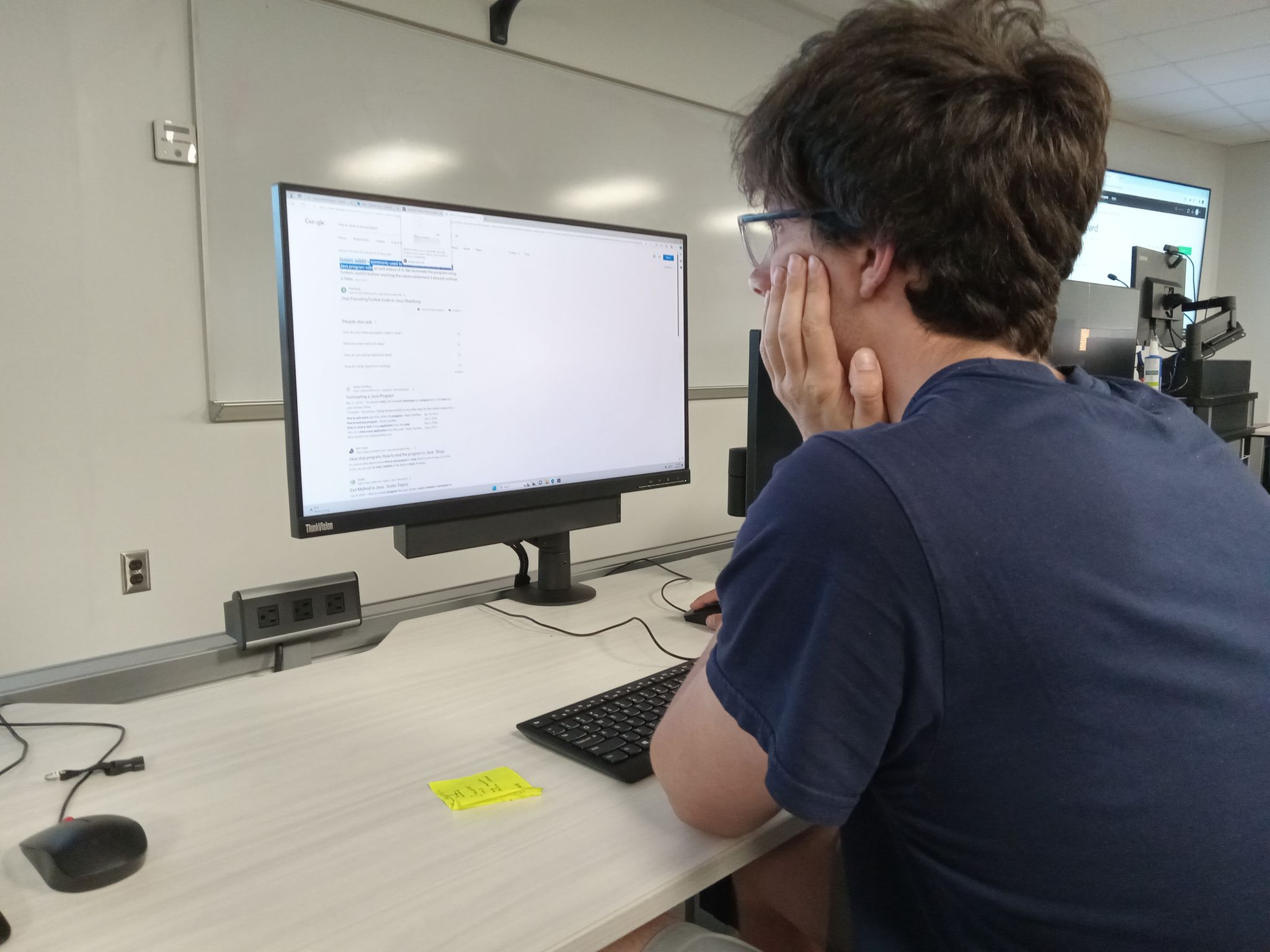 UNCP student Andrew Cart sitting at a computer in the Cyber Defense Education Center