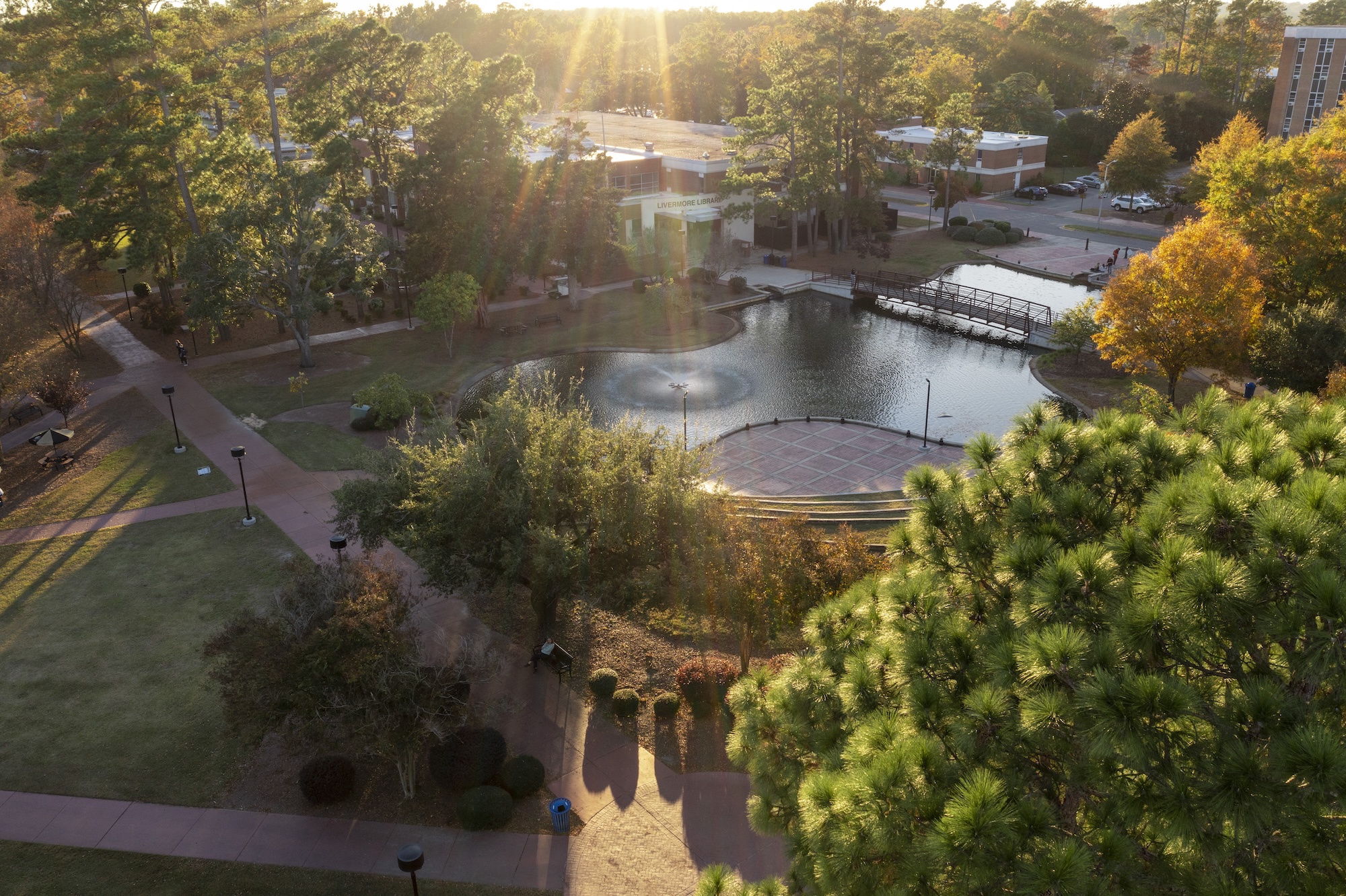 Water feature UNCP with sun shining down and trees