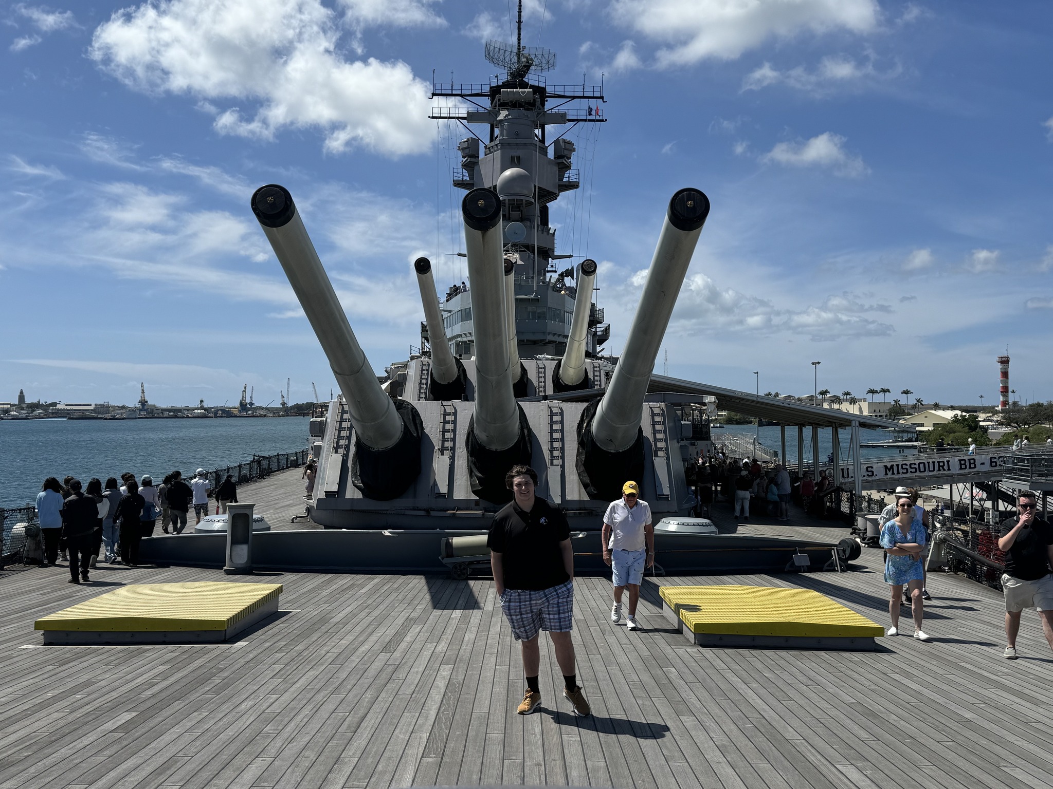 UNCP Research Fellow Mason Schwenneker stands on the deck of a battleship in Pear Harbor
