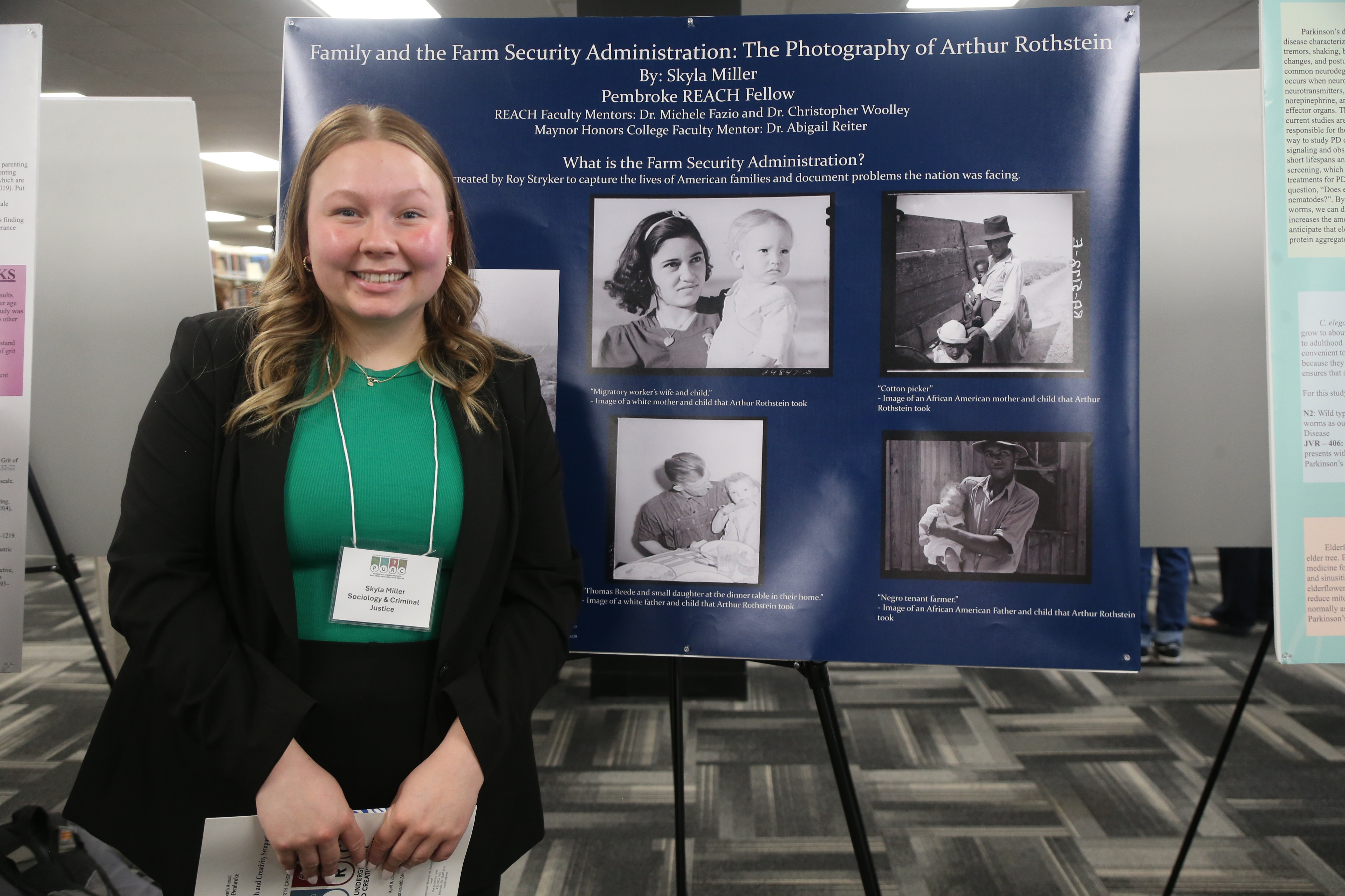 Kayla Miller standing with her poster at a research symposium