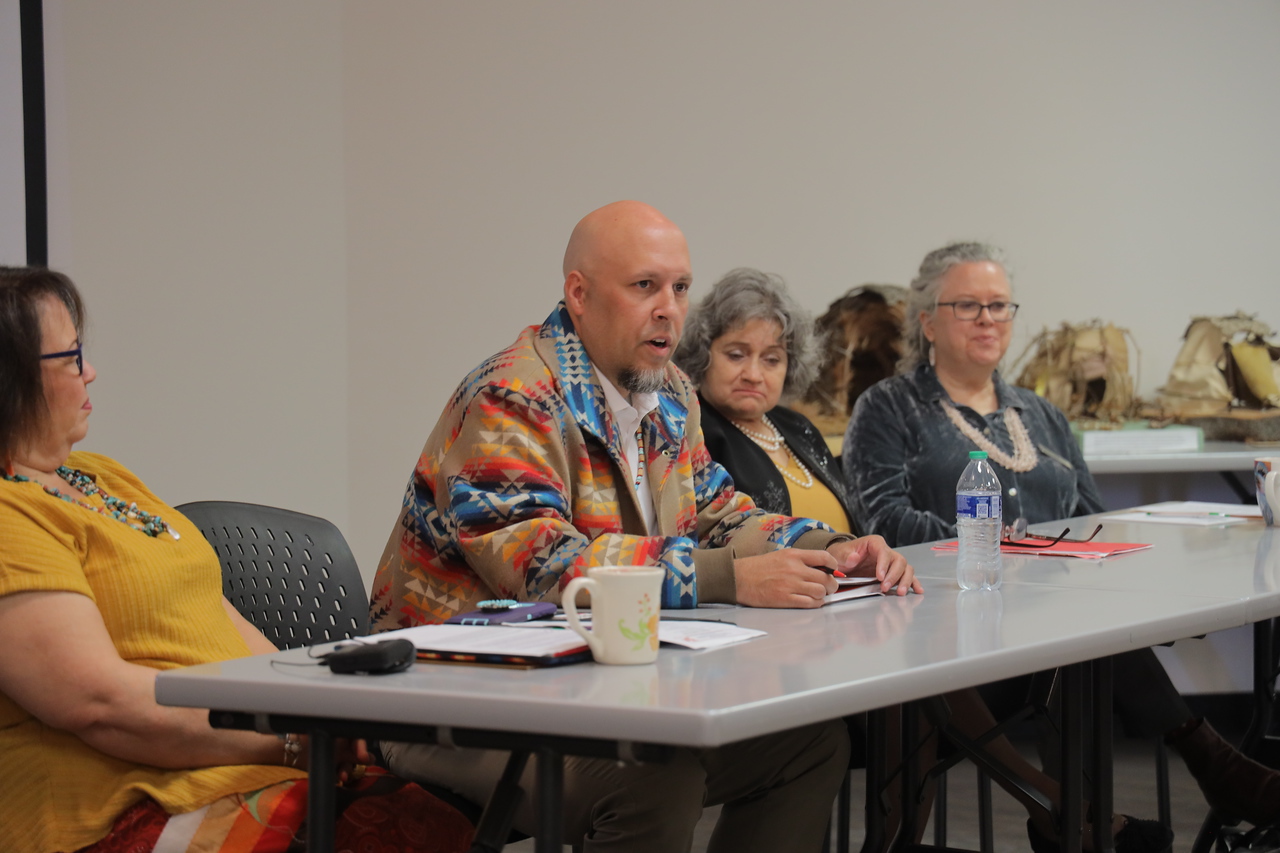 group of American Indian men and women at a table during a conference at UNCP