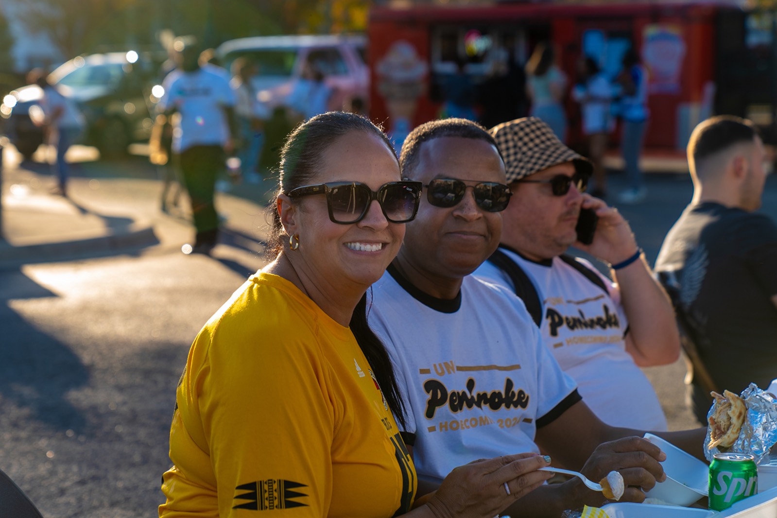 UNCP alumnus eating fair food at Beats and Eats Block Party