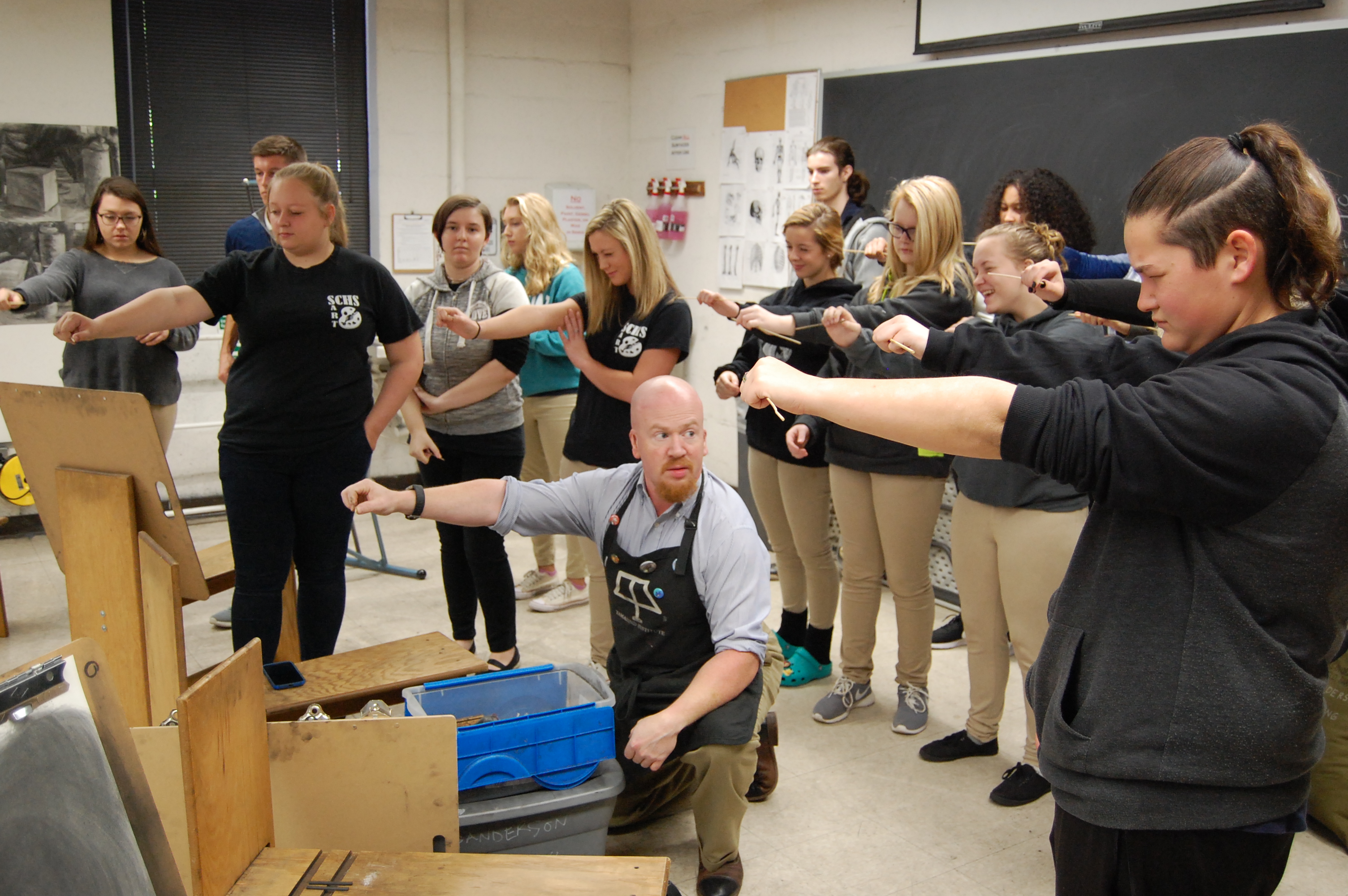 UNC Pembroke printmaking professor working with students in Columbus County High School.