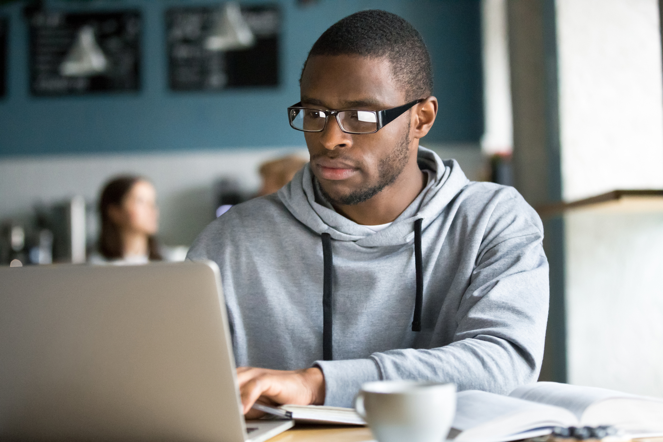 male at laptop with coffee