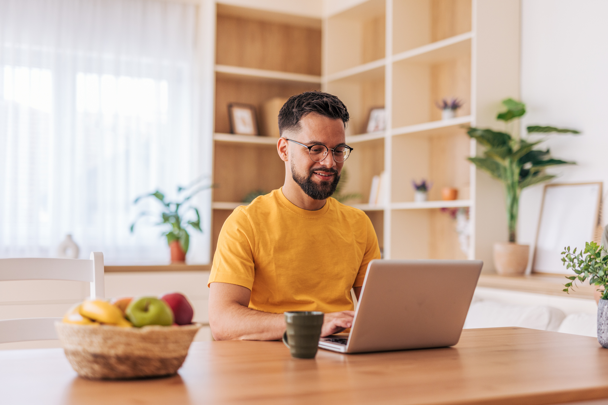 male student at home on laptop