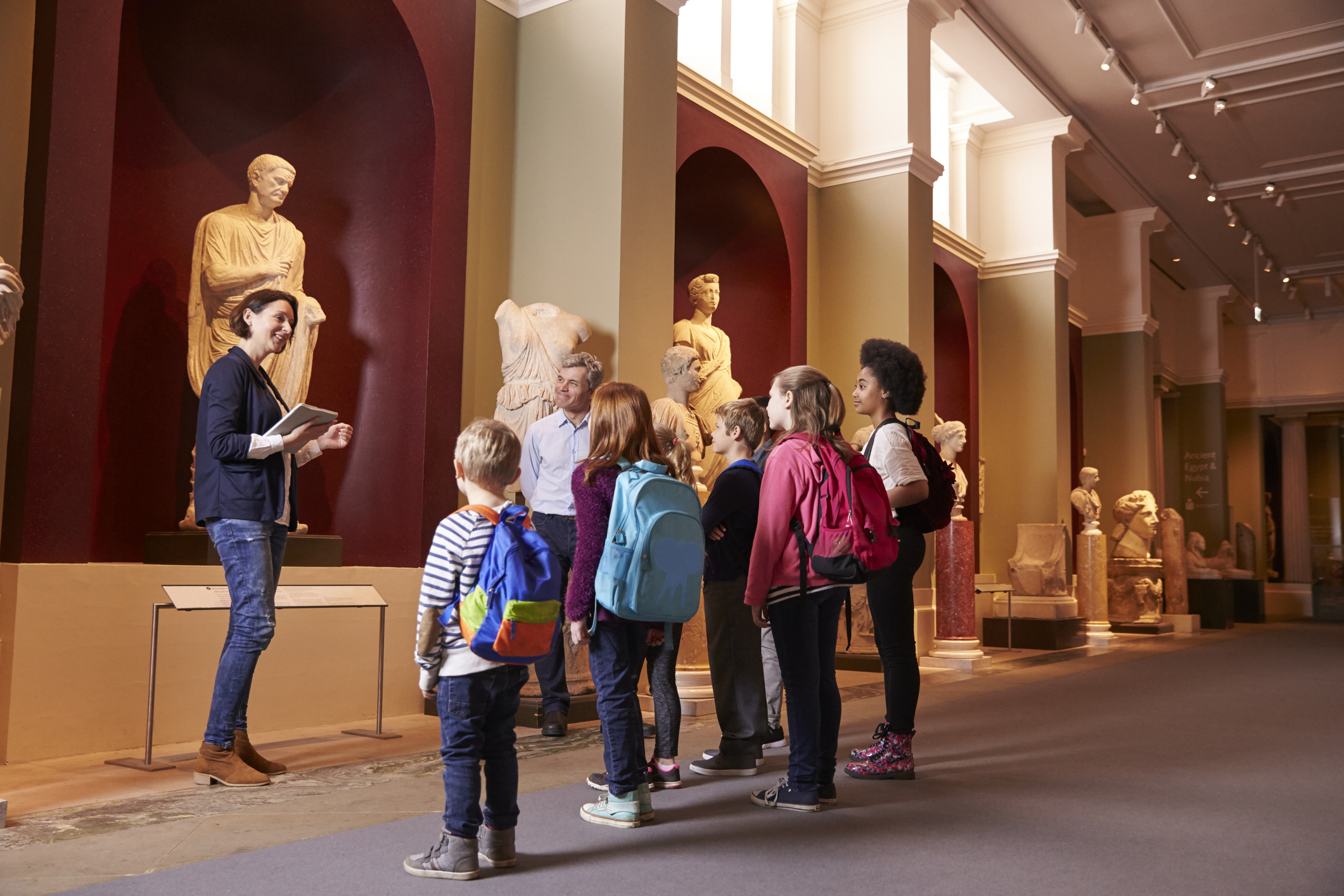 woman at museum with students