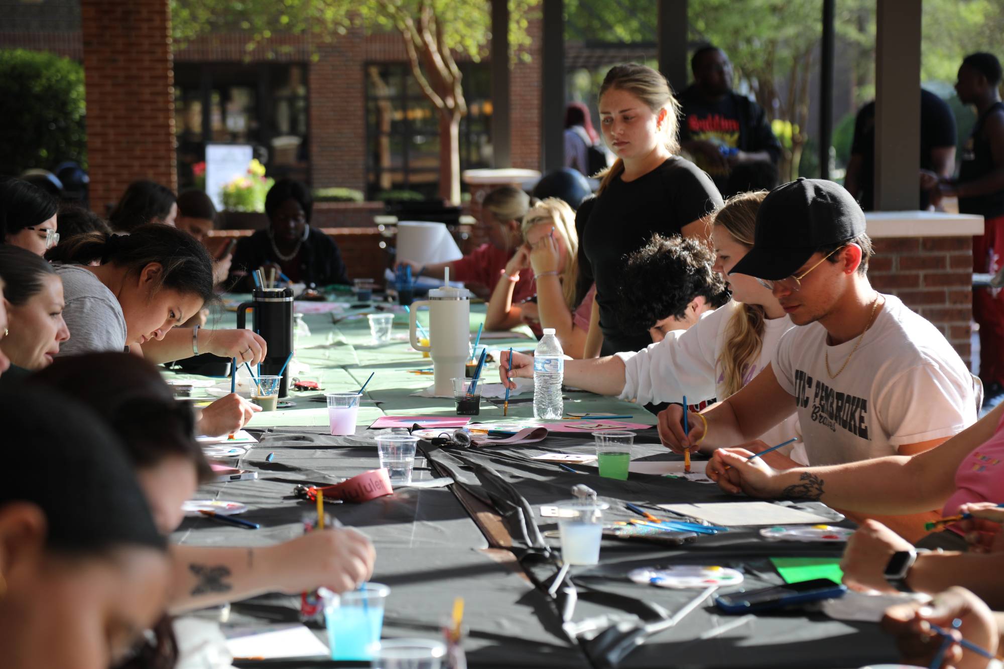 Members of UNCP Greek life outside of the James B. Chavis Student Center enjoying Greek Week Paint Night
