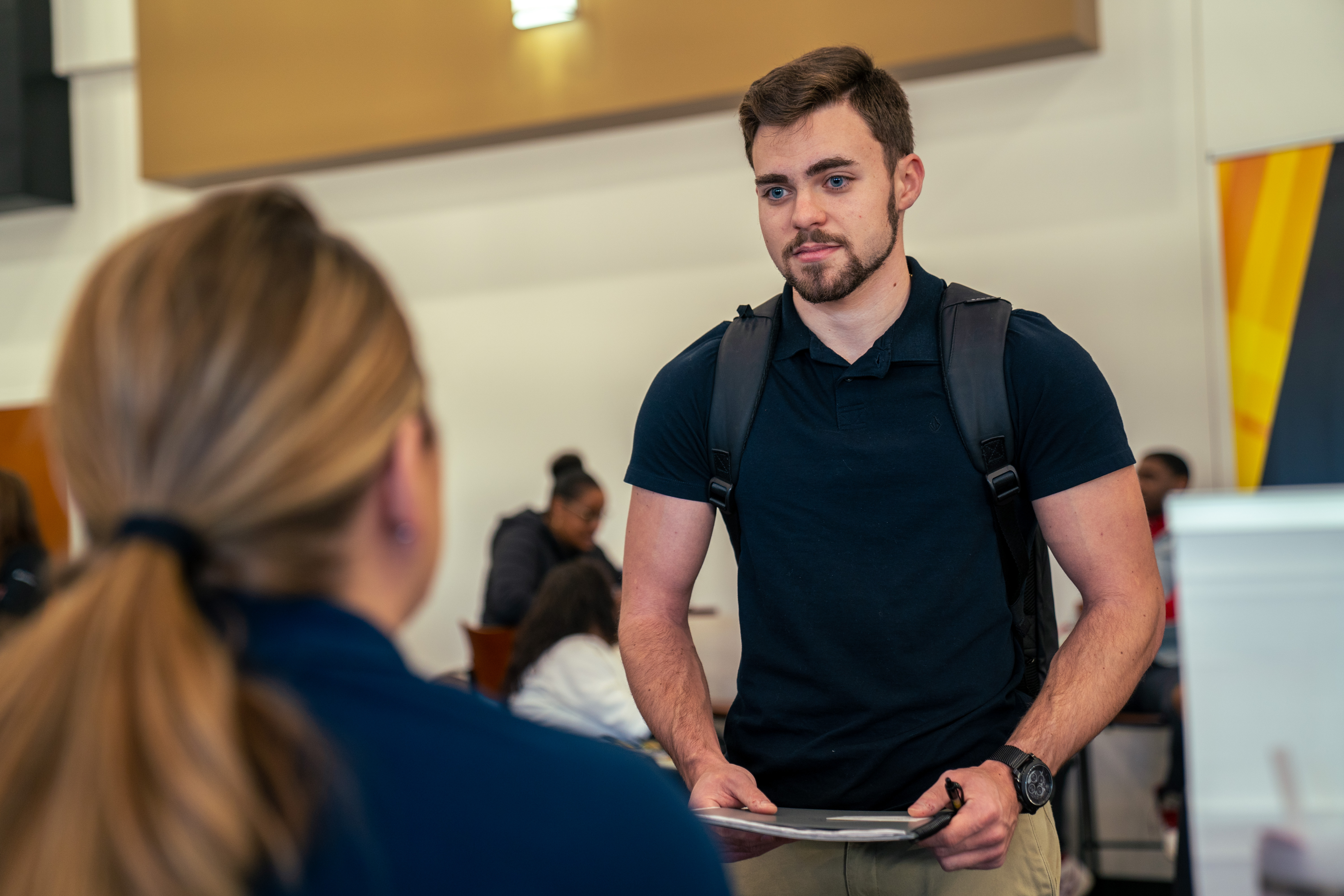 Student speaking with recruiter during UNC Pembroke career fair.