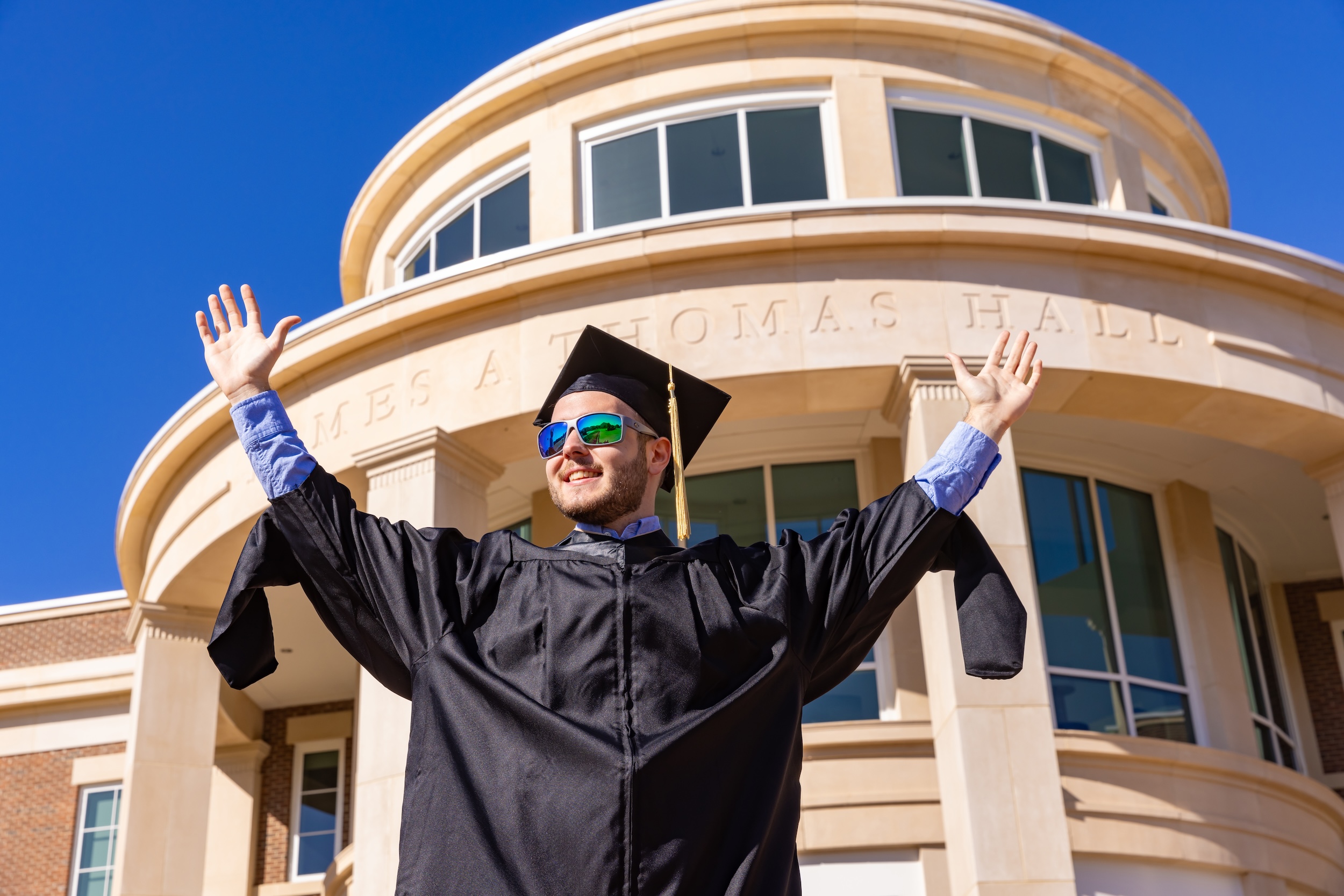 graduate business student arms up unc pembroke