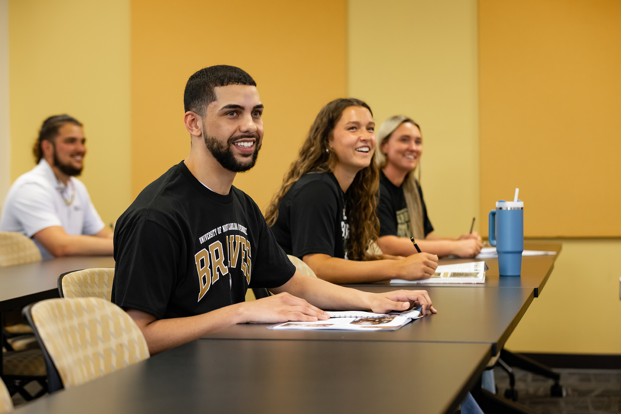 Male and female students at UNC Pembroke seated in a classroom