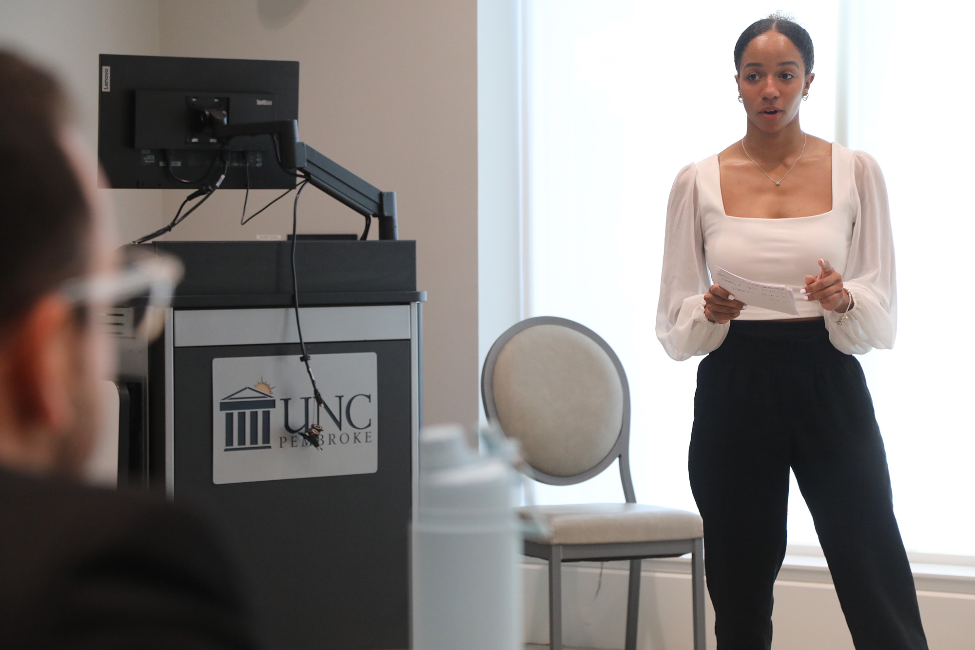 UNCP student presenting to larger group in business class
