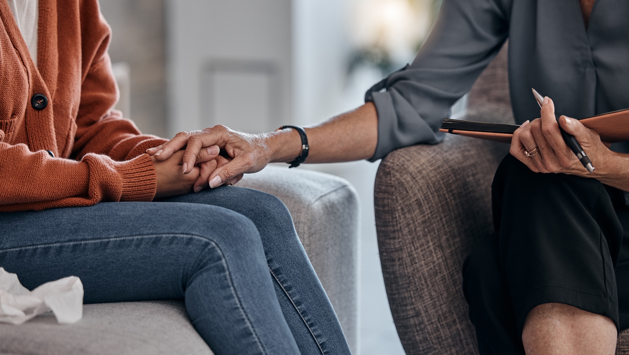 counselor holding patients hand