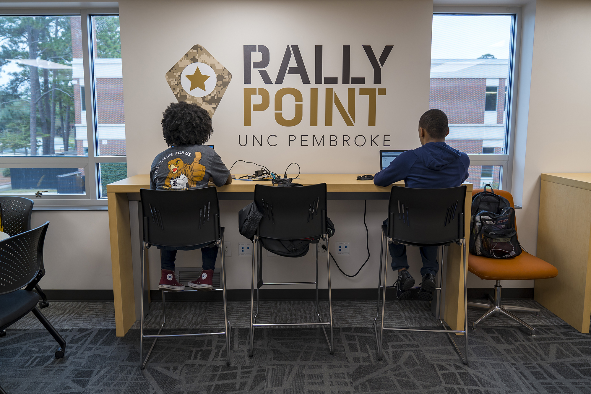 students sitting in front of UNCP Rally Point sign