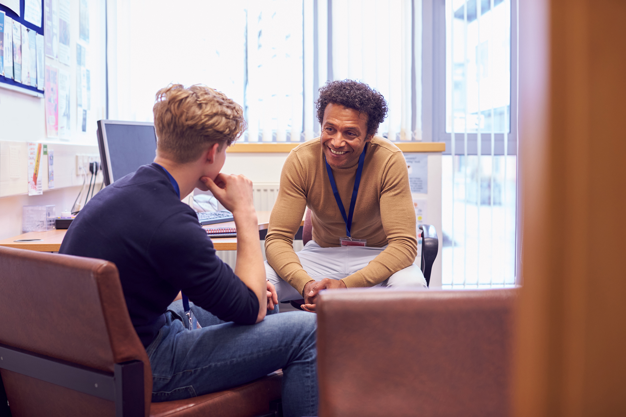 Young man speaking with counselor
