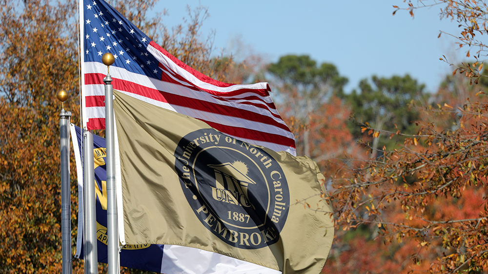 UNCP and US flags waving